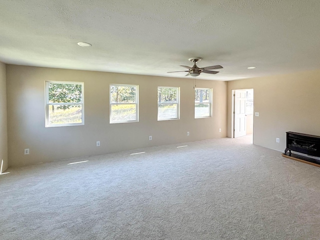 221 Beachwood St, Theodosia, MO 65761 - unfurnished living room featuring carpet floors, a ceiling fan, a wood stove, and recessed lighting