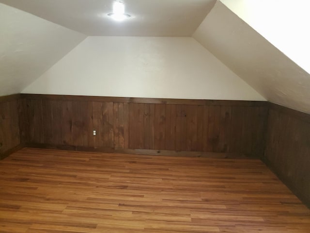 bonus room featuring vaulted ceiling and wood-type flooring