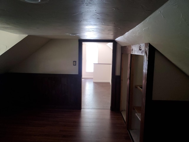 bonus room featuring vaulted ceiling and dark hardwood / wood-style floors