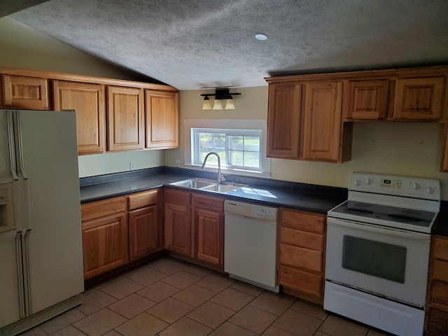 kitchen with a textured ceiling, sink, vaulted ceiling, and white appliances