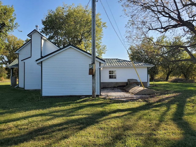 rear view of property with a lawn