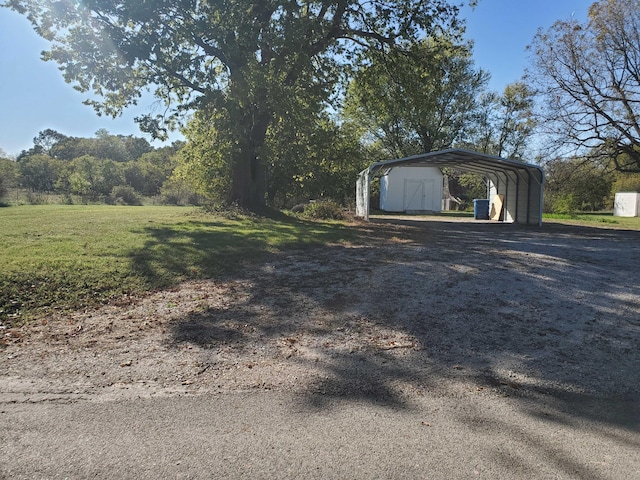 garage featuring a yard and a carport