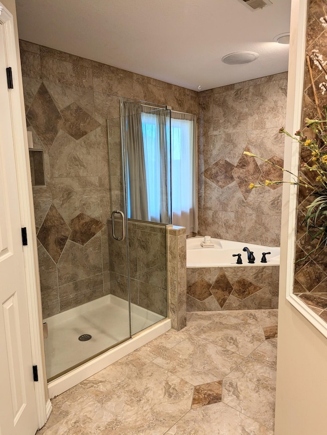 bathroom with separate shower and tub