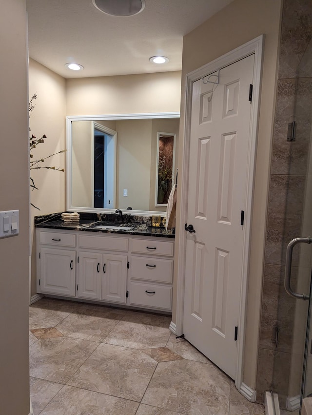 bathroom featuring vanity and an enclosed shower