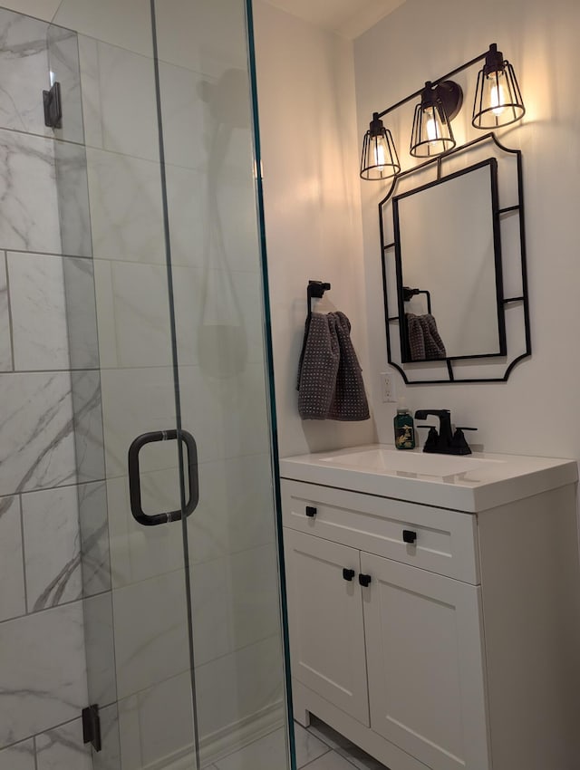 bathroom featuring vanity and a shower with shower door