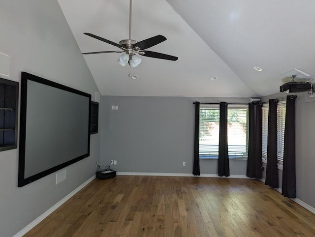 home theater with wood-type flooring, high vaulted ceiling, and ceiling fan