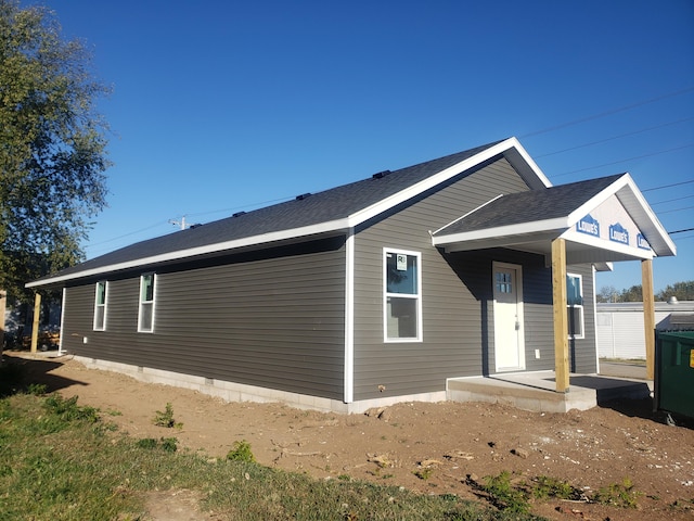 rear view of house featuring covered porch