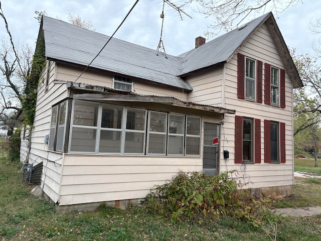 view of front of house featuring a sunroom