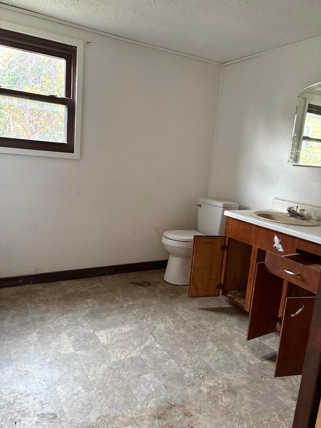 bathroom with vanity, a textured ceiling, and toilet