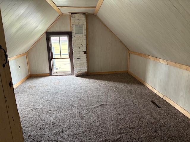 additional living space with light colored carpet and lofted ceiling