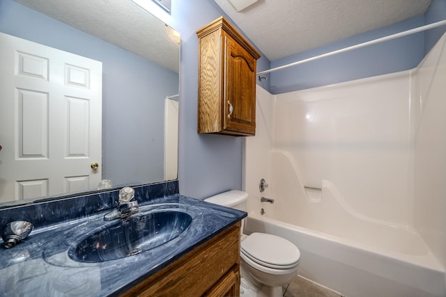 full bathroom featuring toilet, shower / washtub combination, a textured ceiling, and vanity