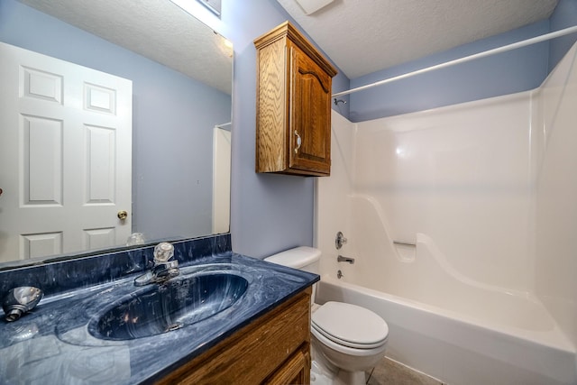 full bathroom featuring vanity, a textured ceiling, washtub / shower combination, and toilet