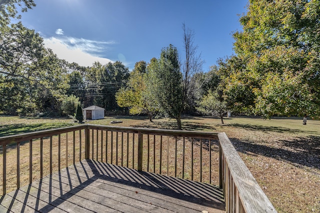 deck featuring a shed and a lawn