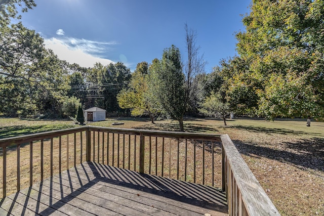 deck featuring an outdoor structure, a yard, and a shed