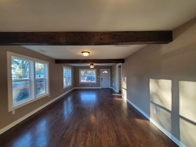 interior space with dark wood-type flooring, ceiling fan, beam ceiling, and a wealth of natural light