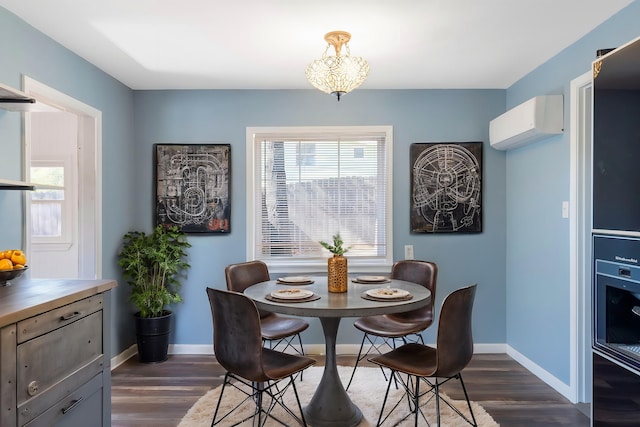 dining room with dark hardwood / wood-style floors and a wall mounted AC