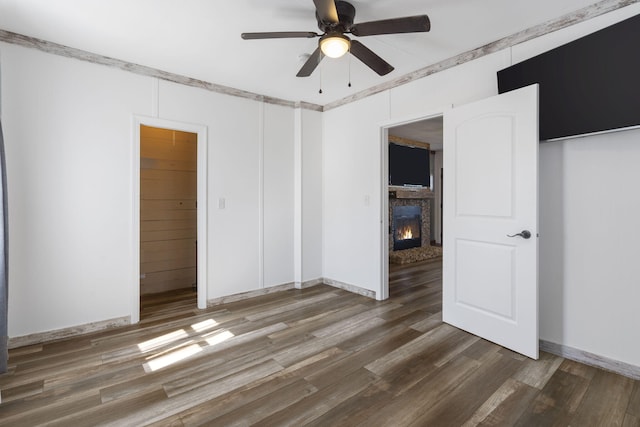 unfurnished bedroom featuring ornamental molding, a closet, dark hardwood / wood-style floors, and ceiling fan