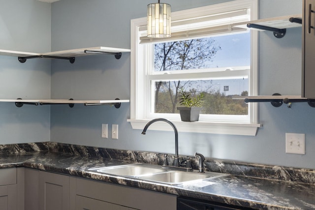 kitchen featuring sink, hanging light fixtures, and gray cabinetry