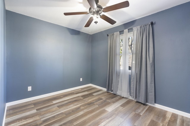 spare room featuring wood-type flooring and ceiling fan