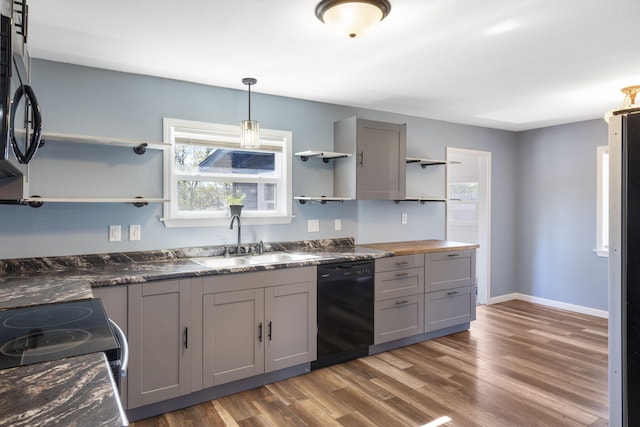 kitchen with gray cabinetry, black appliances, sink, and dark hardwood / wood-style flooring