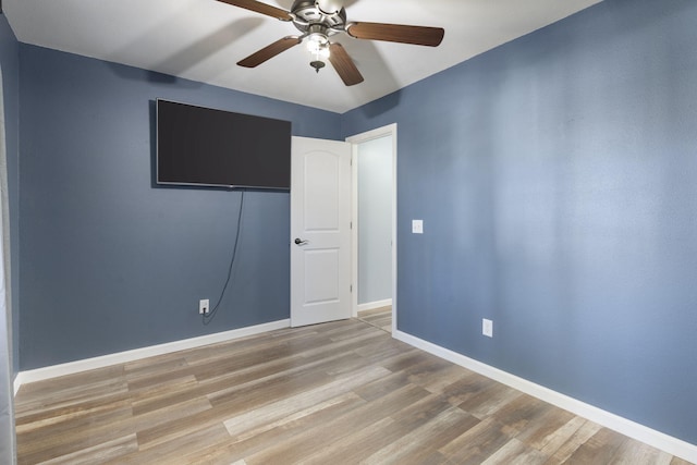 spare room with light hardwood / wood-style floors and ceiling fan