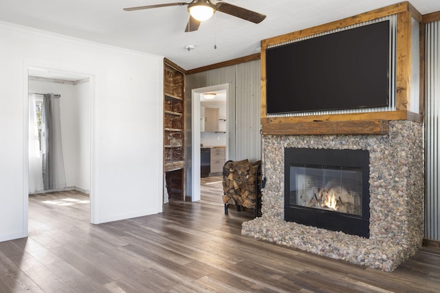 living room with ornamental molding, hardwood / wood-style floors, and ceiling fan