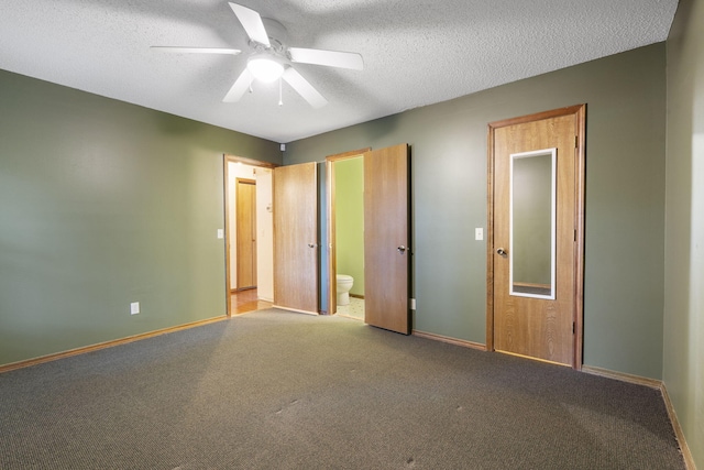 unfurnished bedroom with ceiling fan, carpet floors, ensuite bathroom, and a textured ceiling