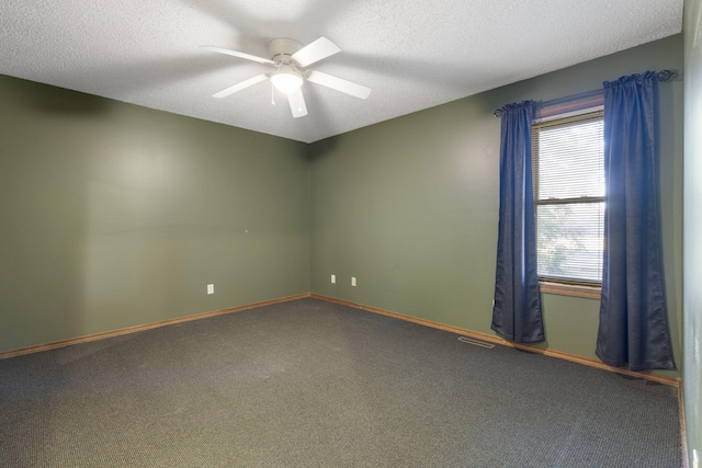 carpeted spare room with ceiling fan and a textured ceiling