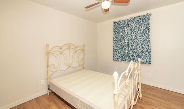 bedroom with ceiling fan and hardwood / wood-style flooring