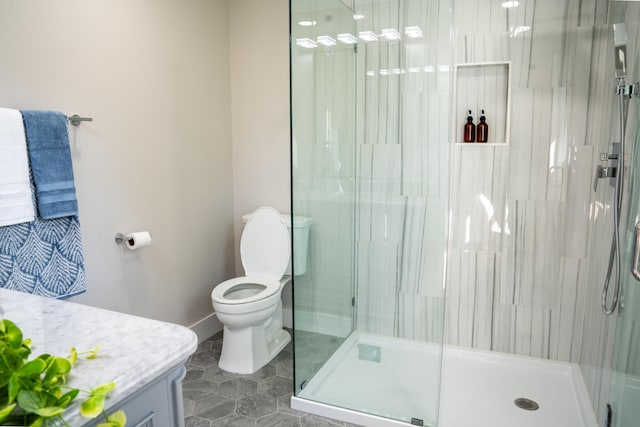 bathroom featuring vanity, tile patterned floors, toilet, and walk in shower