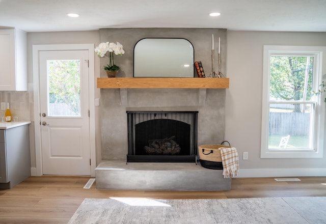 unfurnished living room with a fireplace and light wood-type flooring