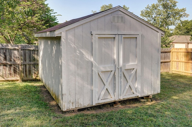 view of outbuilding featuring a lawn