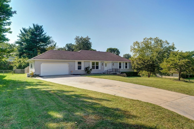 ranch-style house featuring a front lawn and a garage