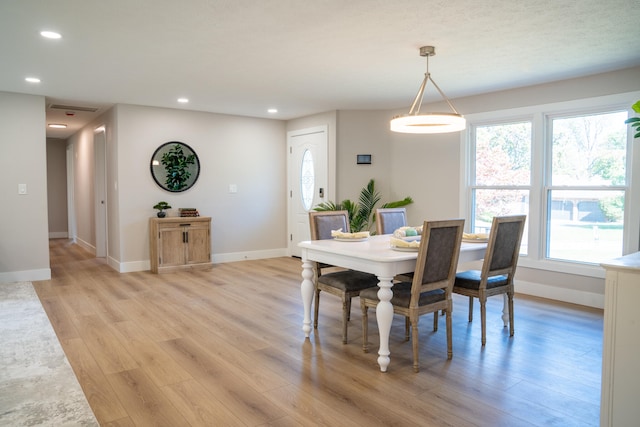 dining area featuring light wood-type flooring