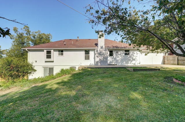 rear view of house featuring a lawn