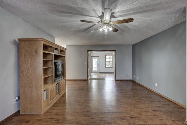 unfurnished living room featuring a textured ceiling, dark hardwood / wood-style floors, and ceiling fan