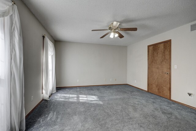 spare room featuring a textured ceiling, carpet floors, and ceiling fan