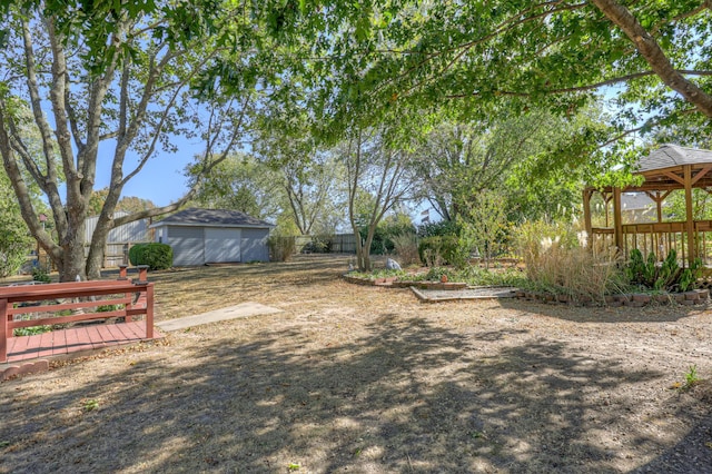 view of yard with a gazebo and an outbuilding