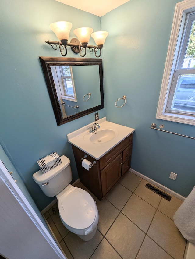 bathroom with vanity, toilet, and tile patterned floors