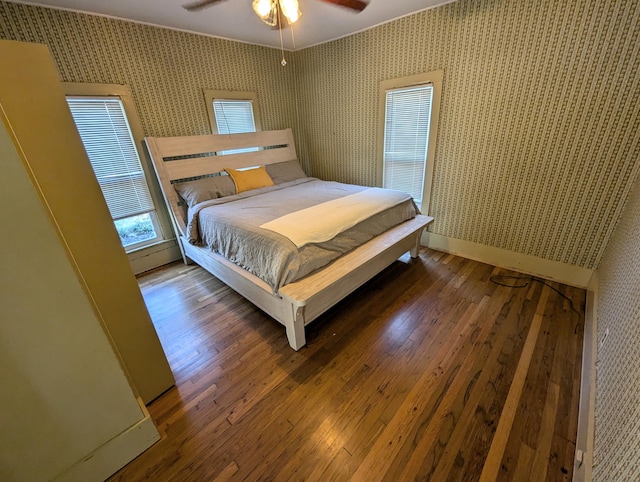 bedroom with dark hardwood / wood-style floors and ceiling fan