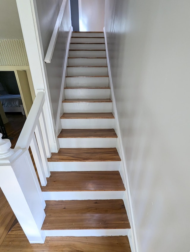 stairs featuring hardwood / wood-style flooring