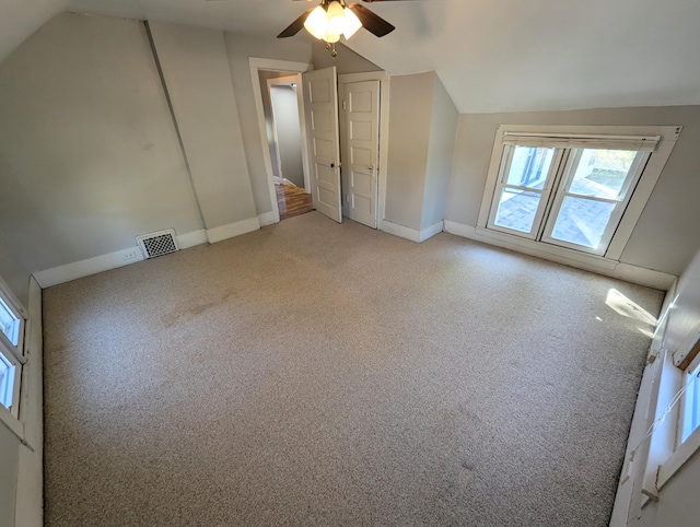 bonus room featuring light carpet, lofted ceiling, and ceiling fan