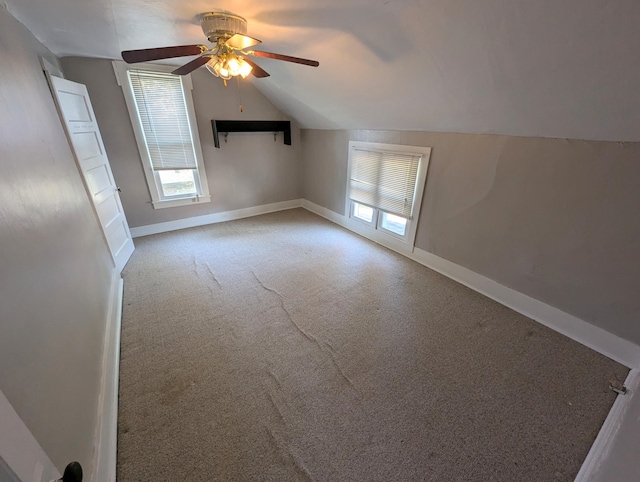 bonus room with carpet floors, ceiling fan, and vaulted ceiling