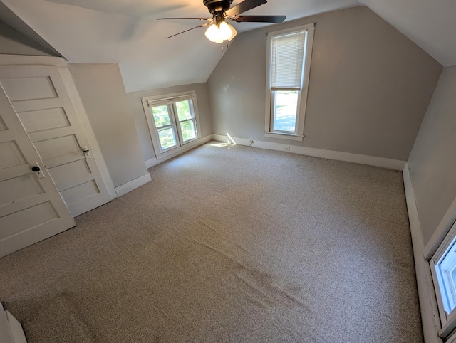 bonus room with ceiling fan, vaulted ceiling, and carpet floors