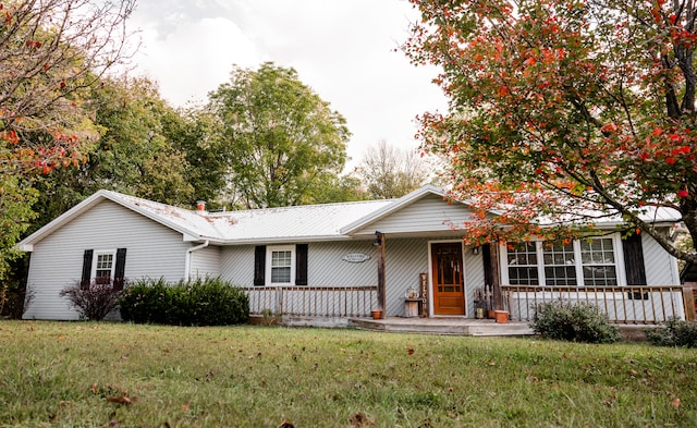 ranch-style home featuring a porch and a front lawn