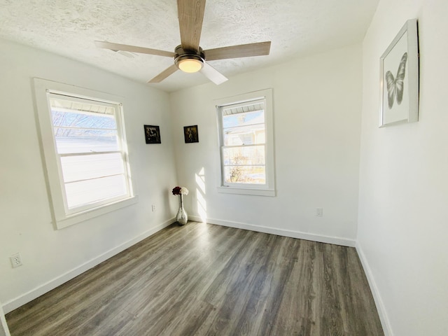 spare room with dark wood-type flooring, ceiling fan, and a textured ceiling