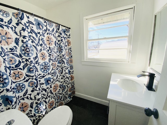 bathroom featuring vanity, curtained shower, and toilet