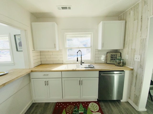 kitchen with dishwasher, sink, white cabinets, and decorative backsplash