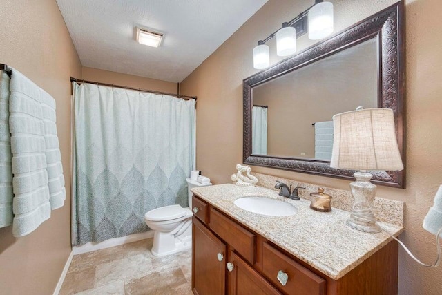 bathroom with toilet, vanity, and a shower with shower curtain