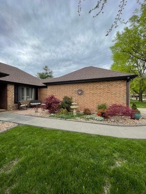 view of side of property with a lawn